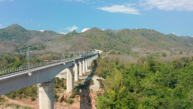 Aerial view of Laos-china railway running through Mekong river bridge, Laos train. Drone shot footage