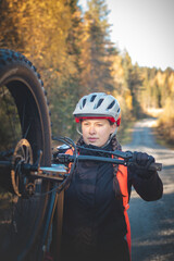 Young likeable lady with a lovely realistic smile while recreationally sporting. Cyclist riding fat...