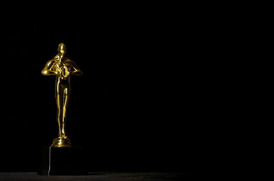 Hollywood Golden Oscar Academy award statue against black background