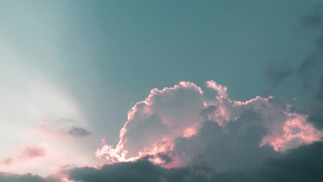 Pastel pink clouds n sun light ray or sunbeam in blue sky TimeLapse