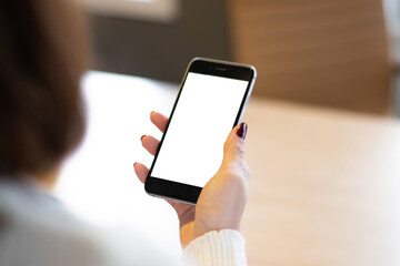 Smartphone mockup image of a woman's hand holding mobile phone with blank screen.