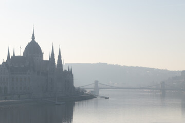 Fototapeta na wymiar Parliament building and Szechenyi chain bridge in morning haze in Budapest, Hungary