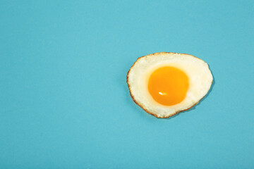Flawless fried egg on the blue background.