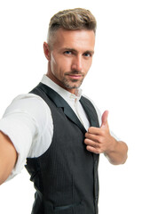 Serious guy in suit vest taking selfie giving thumb gesture isolated on white, thumbs up