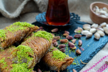 Turkish desserts burma kadayif, Burma kadayif dessert with sherbet - burma kadayif dessert with pistachios served with tea