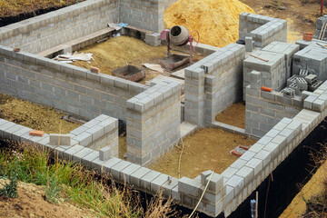 Concrete block building walls. House under construction at a construction site.