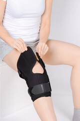 Knee Support Brace on leg isolated on white background. Elastic orthopedic orthosis. Anatomic...