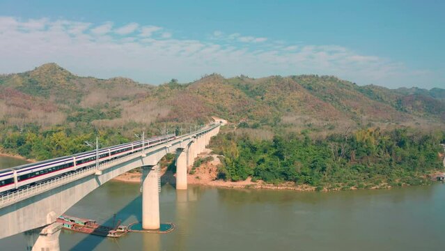 Aerial view of Laos-china railway running through Mekong river bridge, Laos train. Drone shot footage
