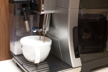 Coffee machine with frother milk container at kitchen, caffee latte, cappuccino maker at home. 