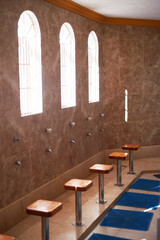 An empty view of a mosque washroom where cleansing rituals are performed during prayers with a row...