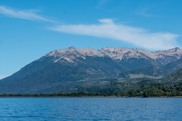 View of the Lake in the mountains in spring. Patagonian Coast Lake. Waves on the coast. Peninsula. Vertical Panoramic View. Vertical photo.