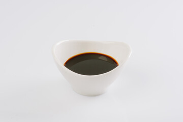 soy sauce in a white bowl on a white background