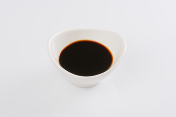 soy sauce in a white bowl on a white background