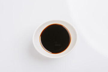 soy sauce in a white bowl on a white background
