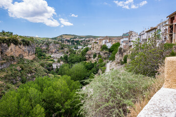 Fototapeta na wymiar City canyon perspective. Alhama de Granada, Andalusia, Spain. Beautiful and interesting travel destination in the warm Southern region. Public street view.