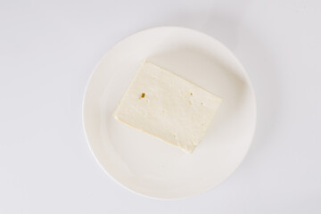 tofu cheese on a white plate on a white background