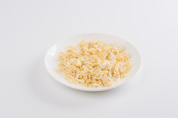 dry garlic on a white plate on a white background