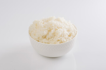 boiled rice on a white plate on a white background