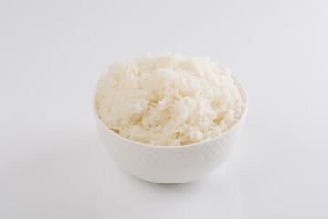 Obraz na płótnie Canvas boiled rice on a white plate on a white background