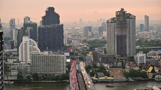 Cityscape building and car traffic on highway with skytrain station at Sathorn, Bangkok