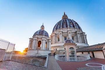 the dome of St. Peter's Basilica in Rome in the rays of the setting sun