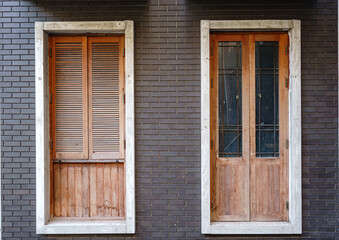 Wooden door and windows on  brick wall.