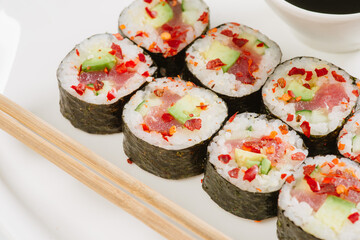 rolling sushi maki on a bamboo mat