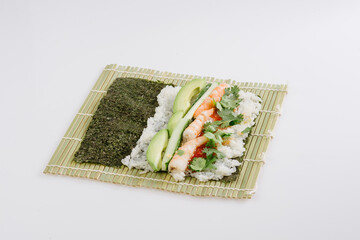 rolling sushi maki on a bamboo mat