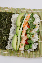 rolling sushi maki on a bamboo mat