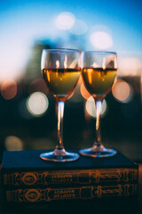 champagne glasses are on the windowsill against the sunset