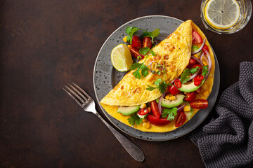 omelette with tomato, avocado onion chili and sweet corn. healthy keto diet low carb breakfast