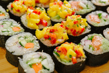 Maki Sushi Rolls set on wooden board. Japanese traditional Cuisine. White background.