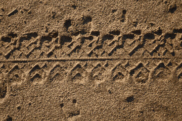 Tire track on a dirt road close-up. Horizontal photo flat lay