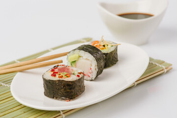 Maki Sushi Rolls set on wooden board. Japanese traditional Cuisine. White background.