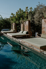 A serene poolside retreat in the Balearic Islands, surrounded by lush greenery and a stunning palm tree reflection. A perfect escape for relaxation, luxury, and Mediterranean charm