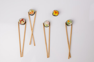 Maki Sushi Rolls set on wooden board. Japanese traditional Cuisine. White background. © mishadp