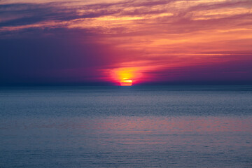 Sunrise at the sea. Beautiful summer view seascape. Amazing sunrise. Morning landscape. Waves with foam. Romantic relax places.