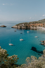 Obraz premium A tranquil scene of beautiful landscape in Ibiza overlooking turquoise waters and white sand beach. 