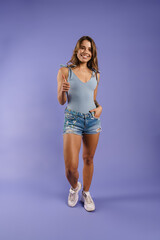 Happy young white woman wearing denim shorts