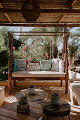 Relaxing garden retreat in Ibiza with sun loungers under lush palm trees. A tranquil Mediterranean escape surrounded by nature, perfect for unwinding in the warm island breeze