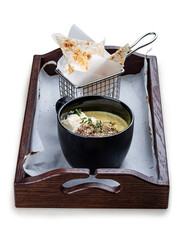 Onion cappuccino soup with amaranth and camembert cheese.