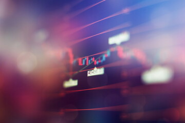 Concept of stock market and fintech. Blurry digital charts over dark blue background.