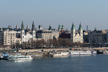 Fototapeta premium Cityscape with orthodox and catholic church on Danube riverbank in Budapest, Hungary