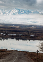 amazing mountains under grey clouds and reflection in mountain lake
