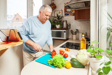 apartments. An elderly man cooks food in the kitchen
