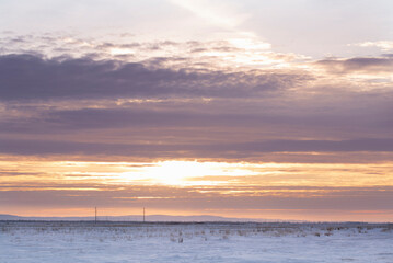 A snowy field at sunset.Winter steppe landscape. The concept of nature - 486074312