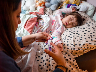 Mother caring for daughter with feeding tube