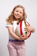 Close up shot of beautiful blonde. Caucasian little girl with toy on white background. Happy childhood concept