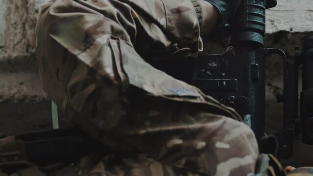 Vertical shot Soldier loading the magazine to M16 automatic rifle. High quality 4k footage