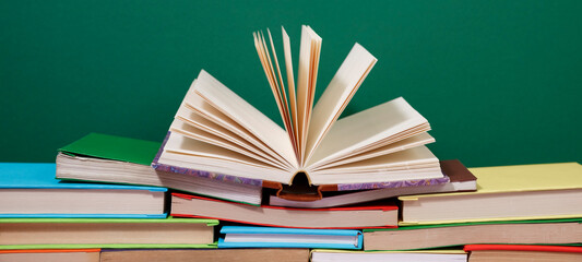 Composition with vintage old hardback books, diary, fanned pages on wooden deck table